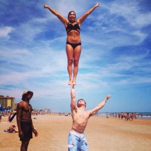 Two of the athletes from the team enjoying their free time on the beach and showing off their skills!